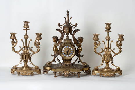 Gothic Clock with a Pair of Candelabra, 19th century: Lot of clock and a pair of candelabra, 19th-20th century. Gothic, Europe. Bronze. Clock height 43 cm (17 inches), dimensions 31 x 16 cm (12 1/4 x 6 1/3 inches). Candelabra's height 34 cm (13 1/3