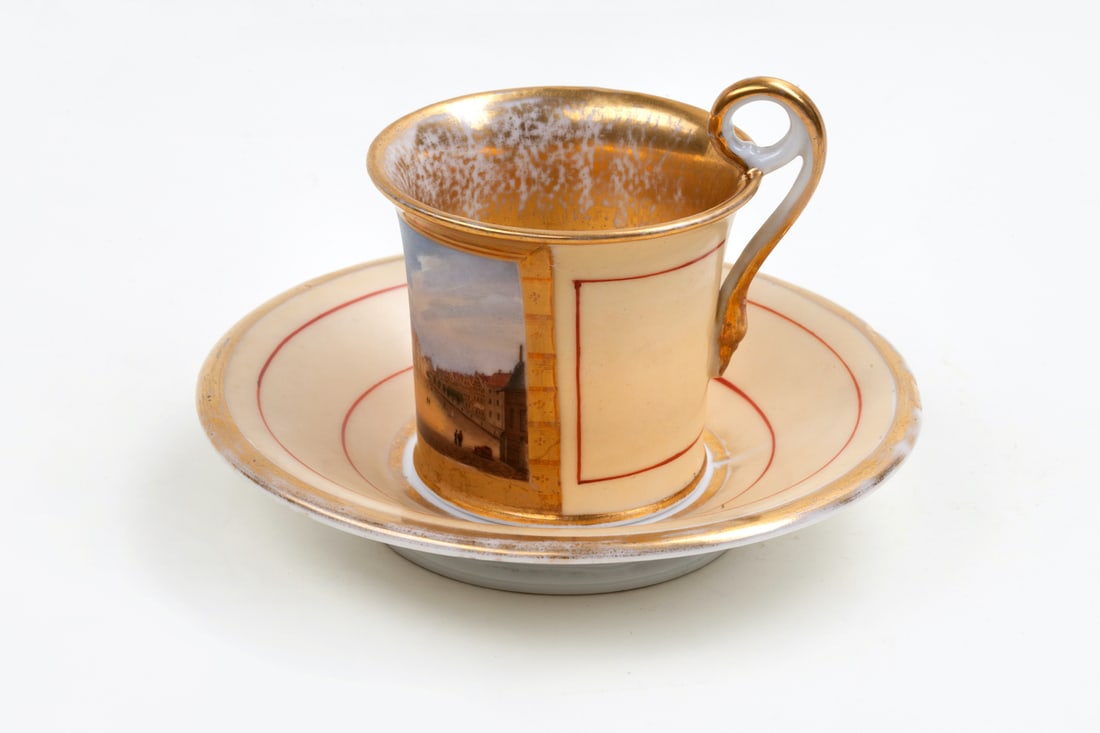 Porcelain Cup with Saucer, 19th century: Porcelain cup with saucer, 1st half of the 19th century. Polychrome painted view of the marketplace of Wismar. Height 7 cm (2 3/4 inches), saucer diameter 14,5 cm (5 3/4 inches). Unmarked.