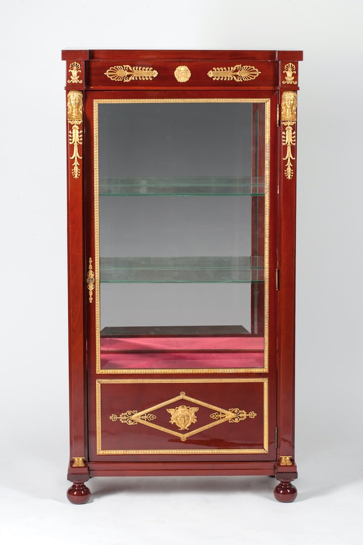 Empire Display Cabinet, 19th century: Desk cabinet adorned with ormolu bronze, 19th century. Empire, Europe. Mahogany wood (solid and veneer) and bronze (casting, chiseling, gilding). It features two glass and one wooden shelf, faceted mi