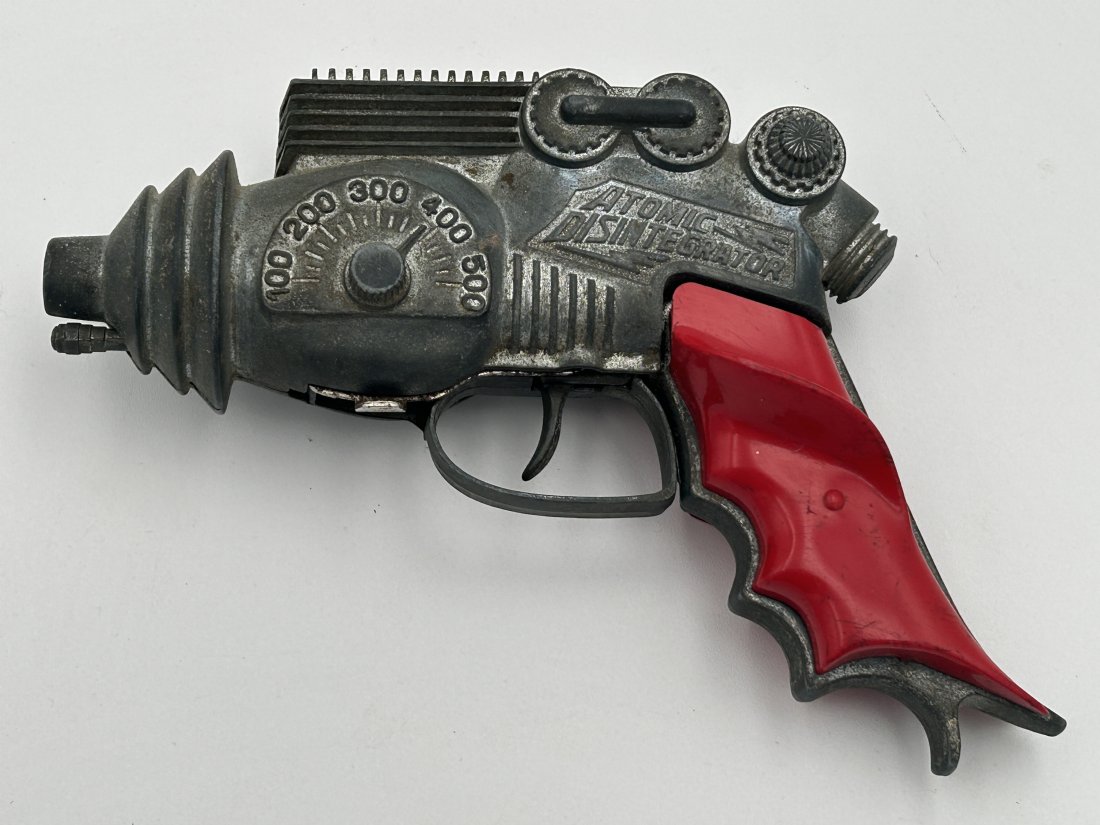 Vintage 1940s Hubley 'Atomic Disintegrator' space /cap gun: Highly collectible space-related toy cap gun, by Hubley. Distinctive aesthetic, with a flared body and red plastic grips.