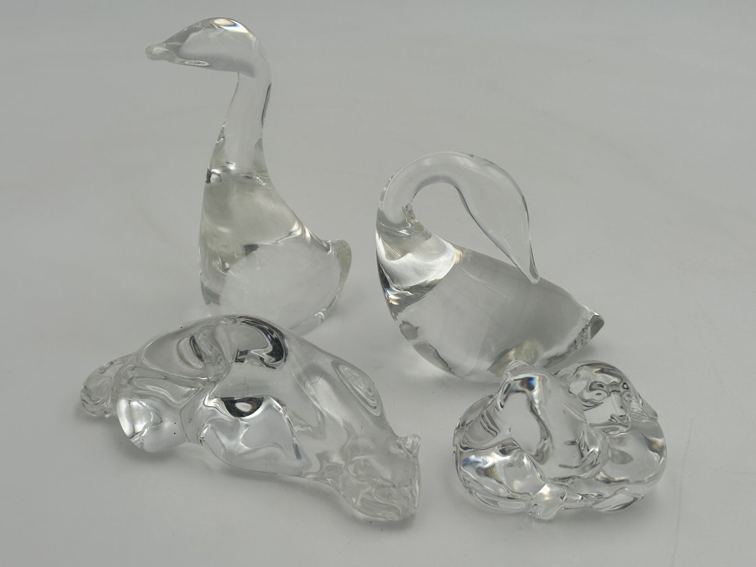 Grouping of 4 signed STEUBEN Crystal Figurines: All are signed, and in excellent condition. Included are a pair of geese, recumbent cat and embracing puppies. Tallest is 5.25"