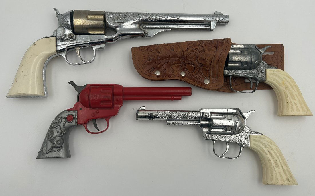 4 Vintage Cap Guns: Larger examples, which include a full-scale Hubley Colt 45 revolver, a matched pair of 'Pony Boy' revolvers with tooled leather holsters [pressed as opposed to hand-done], and a 'Lone Star Rustler'.