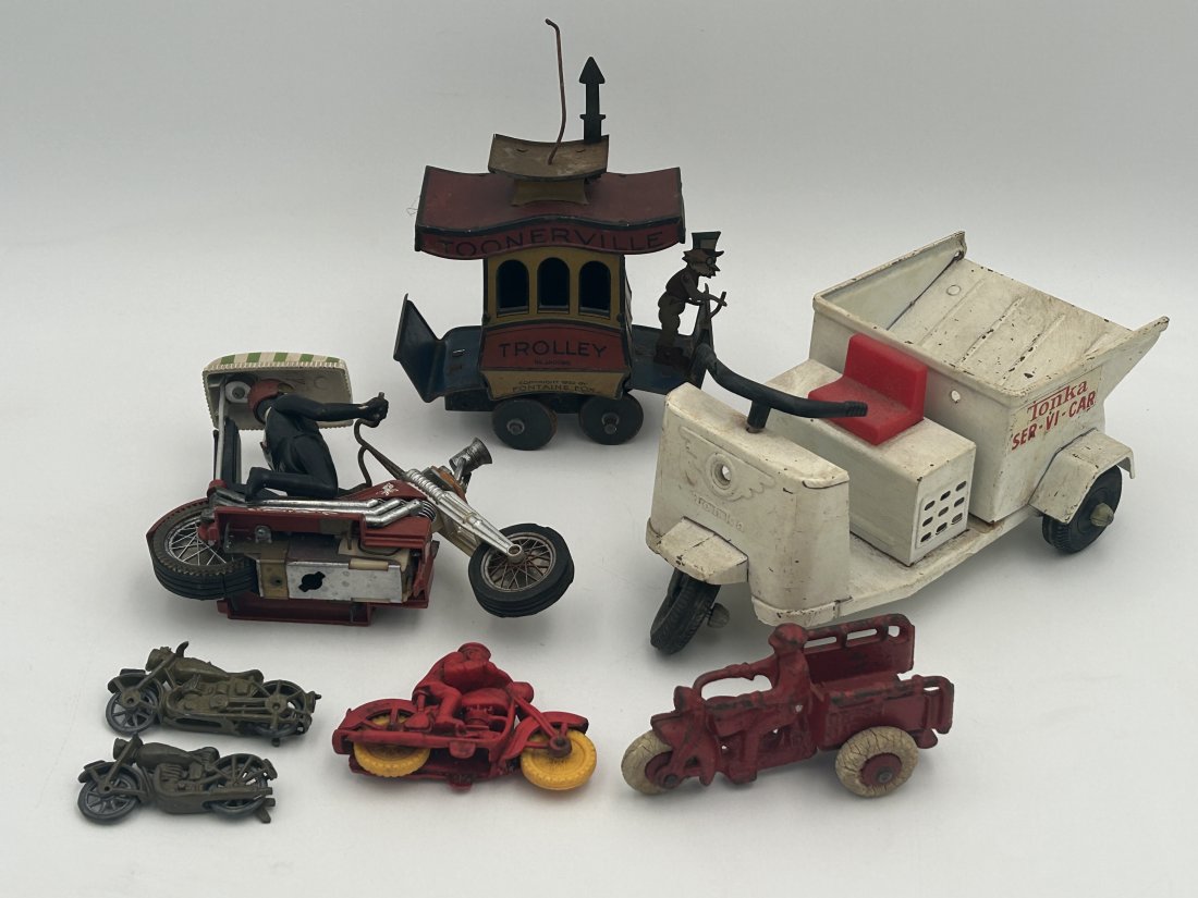 Vintage/Antique Motorcycle Toy Lot: A lot that includes a dated 1922 'Toonerville Trolley', circa 1930s Hubley 'Crash Car', 1971 Hasbro Motorcycle, Auburn motorcycle and circa 1960s Tonka 'Ser-Vi-Car'.