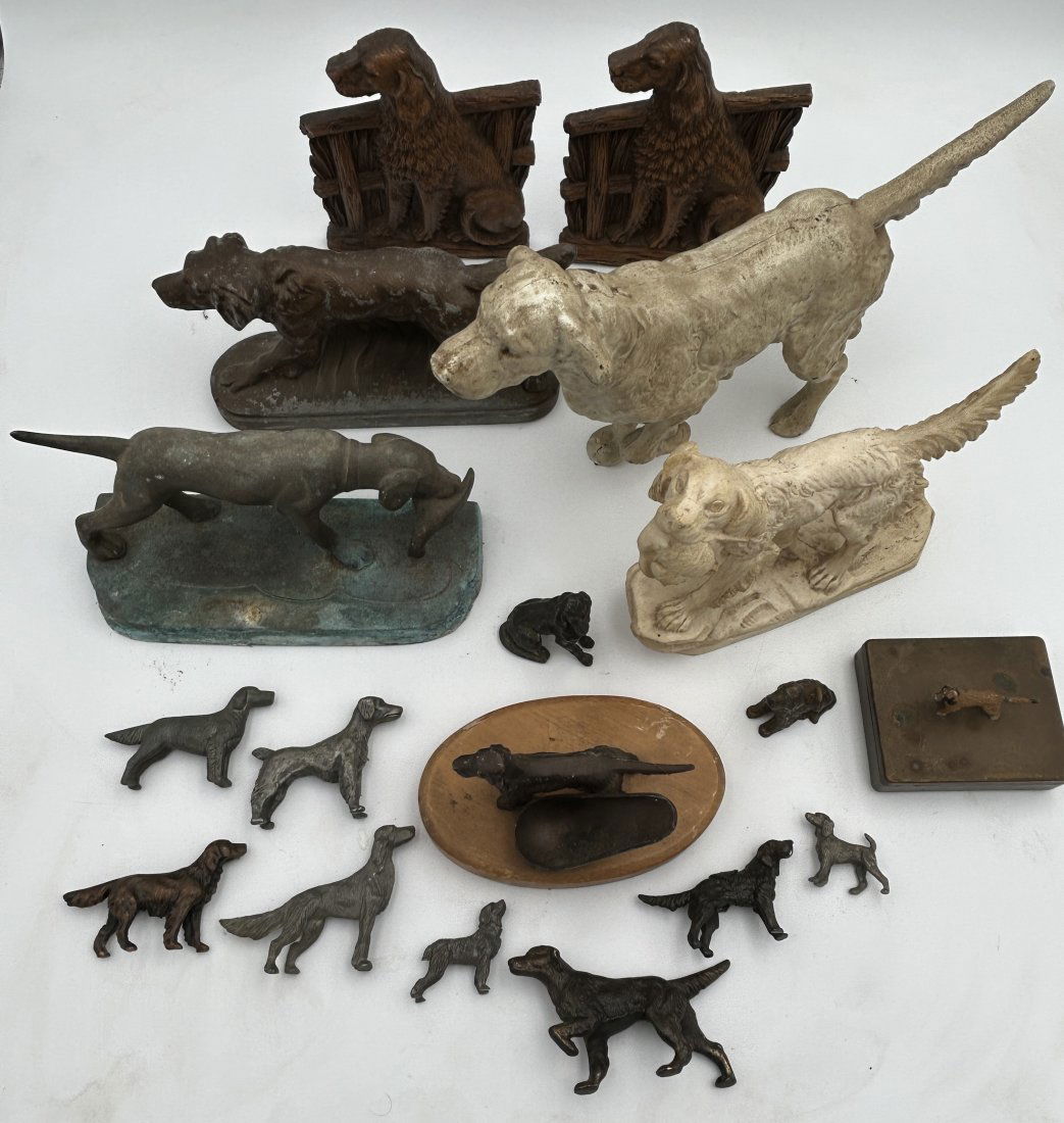 18 Dog Doorstops, Bookends and Figures: A large grouping, including doorstops, Syroco bookends, pipe rest, pot metal figure, and smaller figurines. Largest is 14.25" in length.