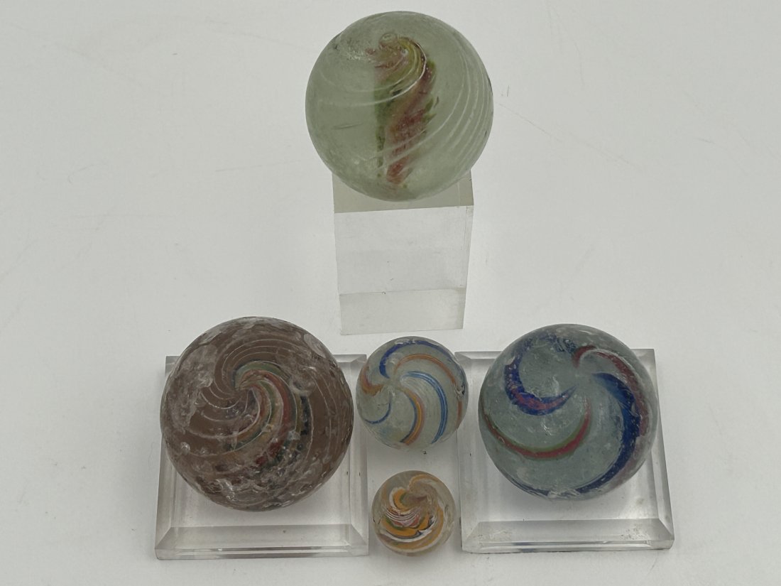 5 Antique 19th Century Hand-Blown German Marbles: All are hand-blown, with visible pontils. There are several larger shooters, as well as traditional-scale examples. Circa 1870s/80s.