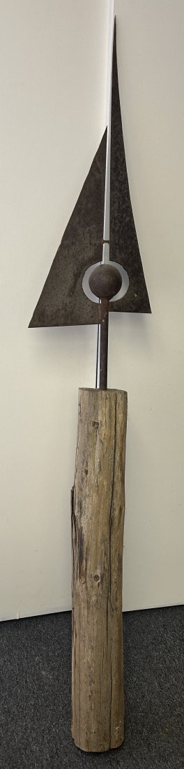 Large Folk Art Driftwood and Iron Spire Sculpture: By an unknown artist, it measures 77.5" in height, the base a large section of driftwood, with a metal spire projecting from it [possibly representing a sailboat and setting sun].