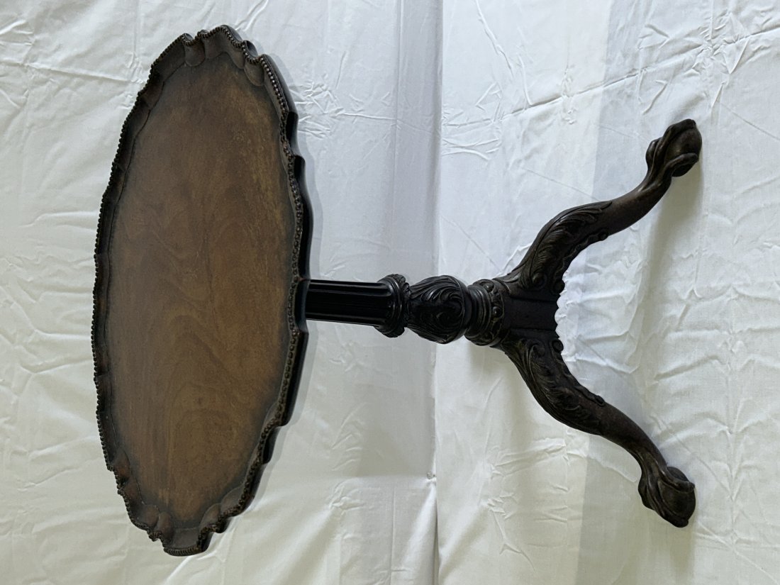 Antique Period Chippendale Pie Crust Table: Of the upmost quality and craftsmanship, with a finely carved base with acanthus leaf motif, claw and ball feet, and a deck carved from one piece of wood- the beading is not applied trim but carved [a