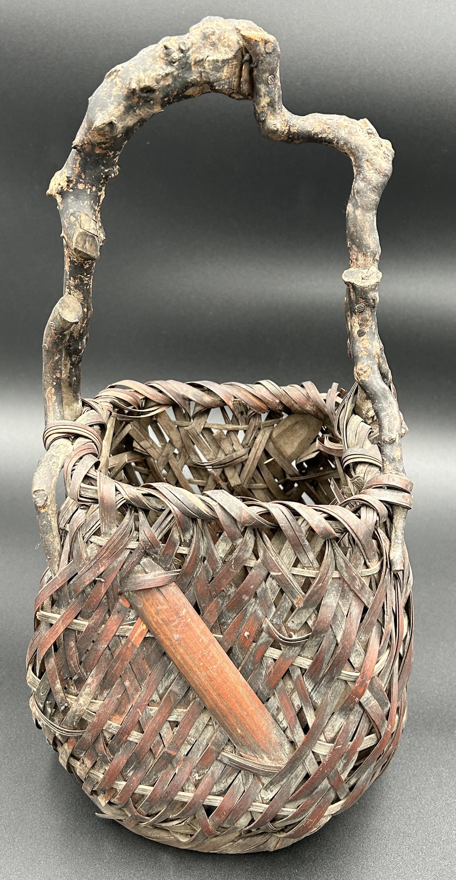 Antique japanese meiji period ikebana bamboo basket: It has a fluid, natural form with bamboo spliced inlay. Good condition throughout. Meiji Period, likely late 19th century. 15" tall.