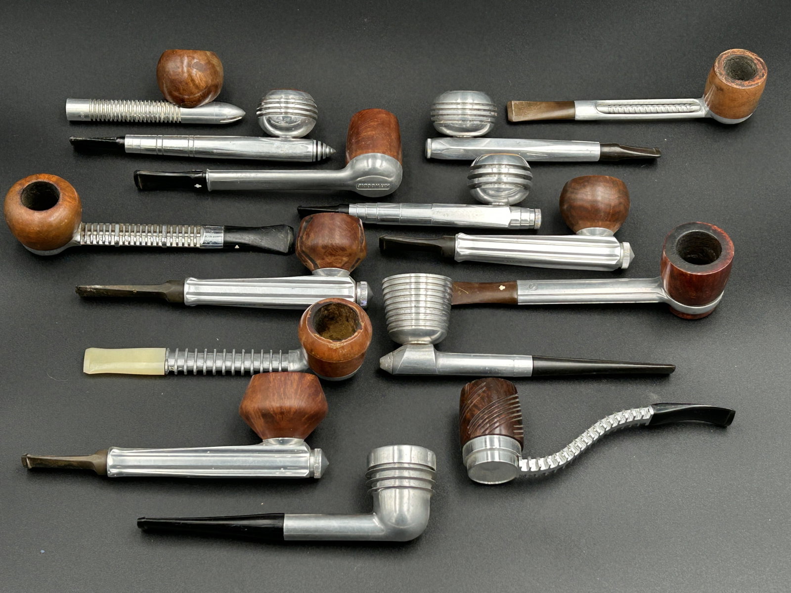 15 vintage aluminum 'Radiator' tobacco pipes: A fine grouping of rare vintage [1930s-1950s] 'Radiator' aluminum tobacco pipes, with some unusual examples and various makers. Makers include Kirsten, Yello Bole, Kaywoodie, Viking and Falcon.