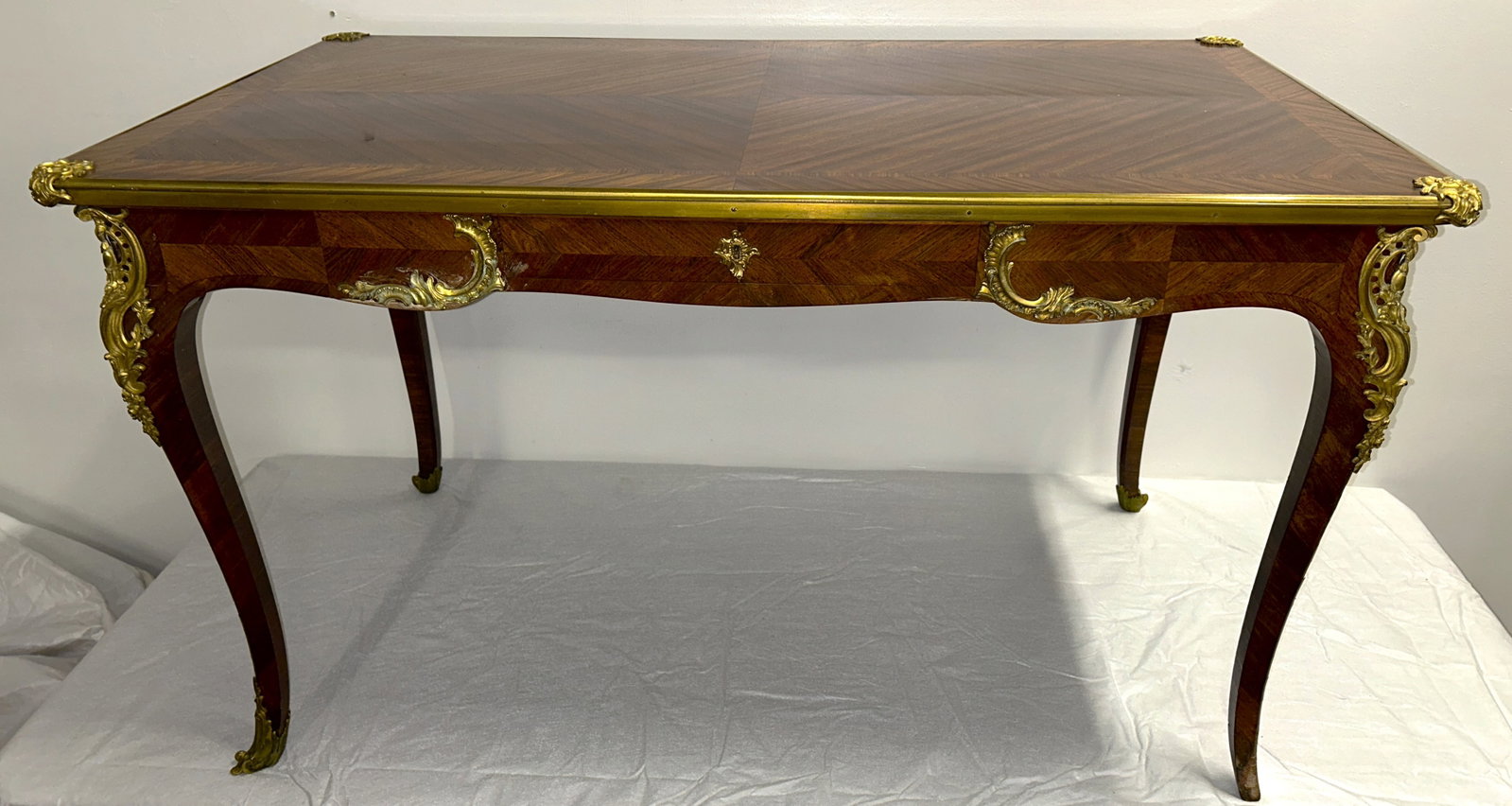 Circa 1900 Napoleon III Style Writing Desk: Book matched veneer and ormolu trim add visual interest. A turn of the century example. 47" by 27" by 27.5" Original Key is present.