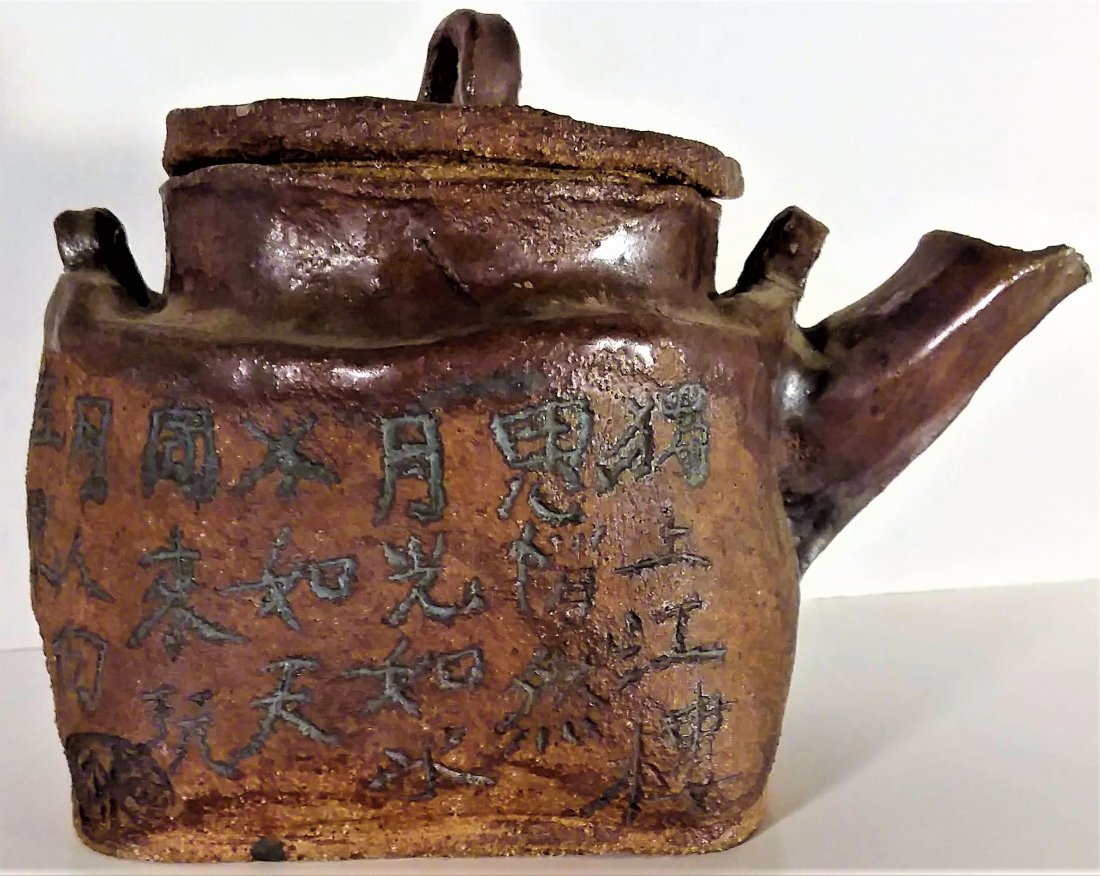 Exceptional Japanese Raku Ware Tea Pot: Exceptional Japanese Raku Ware Tea Pot19th. Century, hand potted, this Japanese pottery vessel is simple covered with bold and deeply cut clerical style calligraphy. Rich brown glaze, fine condition. 