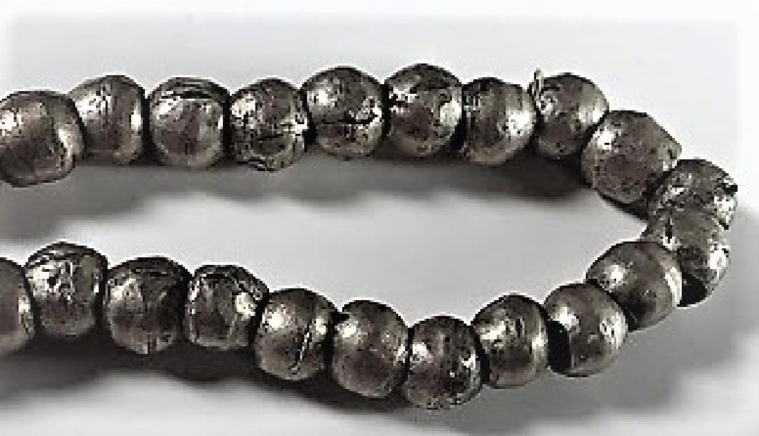 Antique African Hammered Silver Beads: Antique African Hammered Silver Beads Of high grade silver, each anvil formed, 100 fiber strung beads of strong weight and old, likely of the 18th-19th century. Nice condition, un-polished, in this co