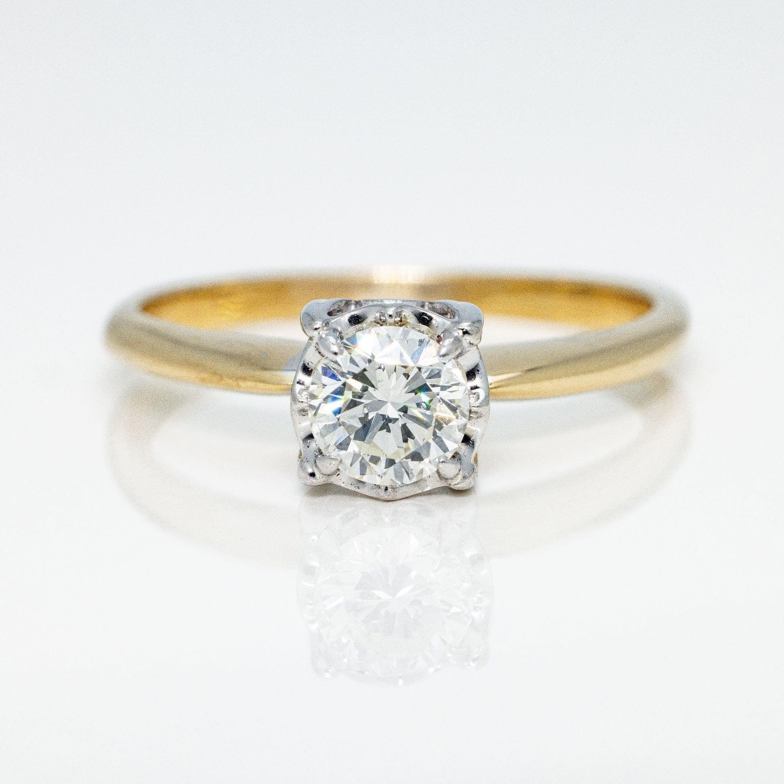 Vintage14kt Gold Diamond Solitaire Engagement Ring: A high-quality solitaire diamond engagement ring with a yellow gold shank and white gold head, featuring an open gallery. The diamond is stunning with no chips or abrasions which is rare for such an o