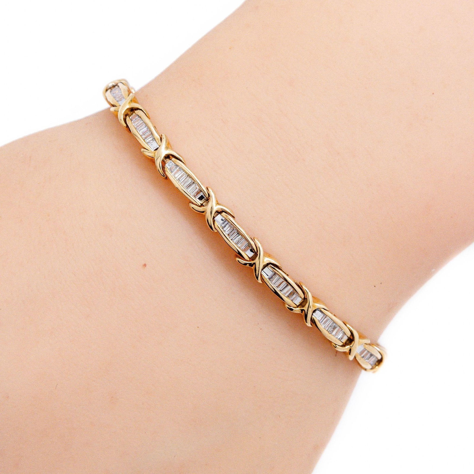10kt 1.50 ctw Baguette Diamond Tennis Bracelet: A very fine tennis bracelet featuring 1.5 ctw channel set natural baguette cut white diamonds, solid yellow gold and a timeless look. Safety chain included for added safety. ATTENTION- Hannosh's will 