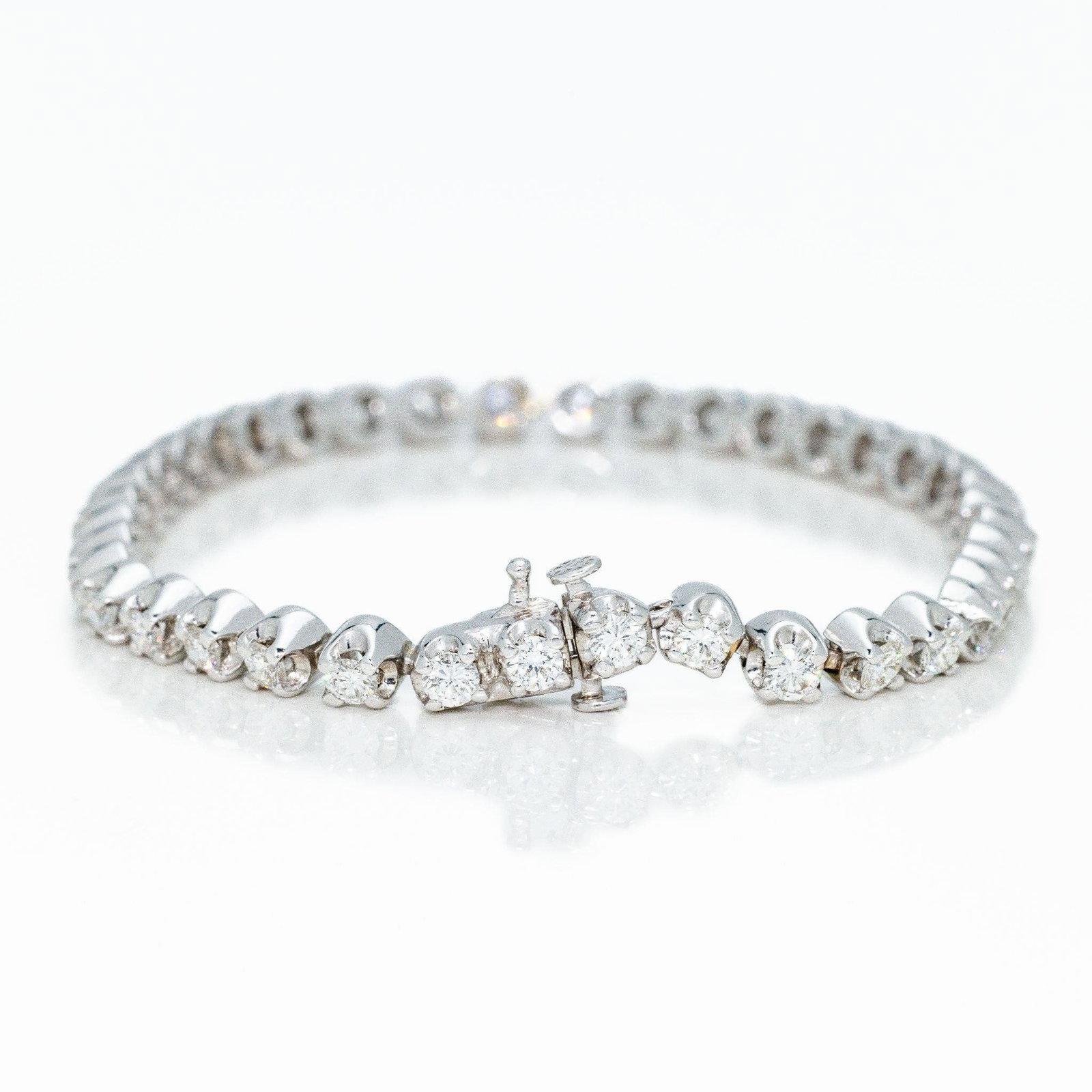 14k White Gold 4 ctw Round Diamond Tennis Bracelet: A very fine diamond tennis bracelet with 4 ctw round diamonds and a very solid, heavy build that is flexible yet sturdy. This diamond tennis bracelet is extremely high end with 100% natural, earth min