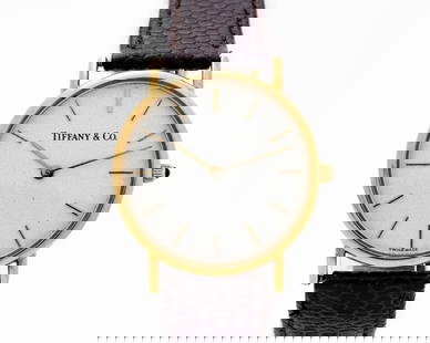 Vintage Tiffany & Co. W115 14kt Solid Gold Watch: Tiffany & Co. - 14kt Yellow Gold - Swiss Quartz - Vintage Leather Strap Watch A genuine vintage Tiffany & Co. wristwatch crafted in solid 14kt yellow gold, featuring a clean factory white dial with go