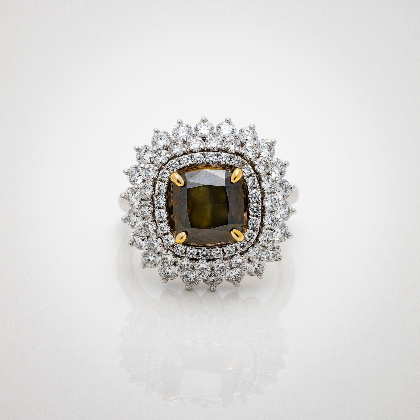 18kt GIA 4.34 CTW Fancy Green Cushion Diamond Ring: An exceptional and highly important diamond ring centered on a GIA-certified 2.54 carat Fancy Greenish Brown cushion modified brilliant; set within a masterfully executed three-tier halo in 18kt