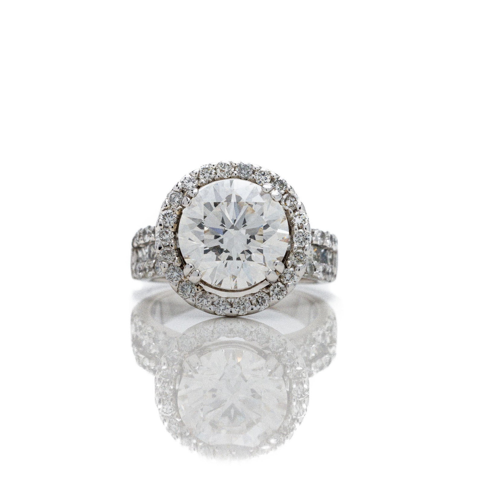 14kt White Gold 5.50 ctw Diamond Engagement Ring: A very fine diamond engagement ring featuring a MASSIVE 4 carat diamond in the center. The round diamond is graded by IGI as a VS1 G color. The diamond is LAB grown while the accent diamonds are