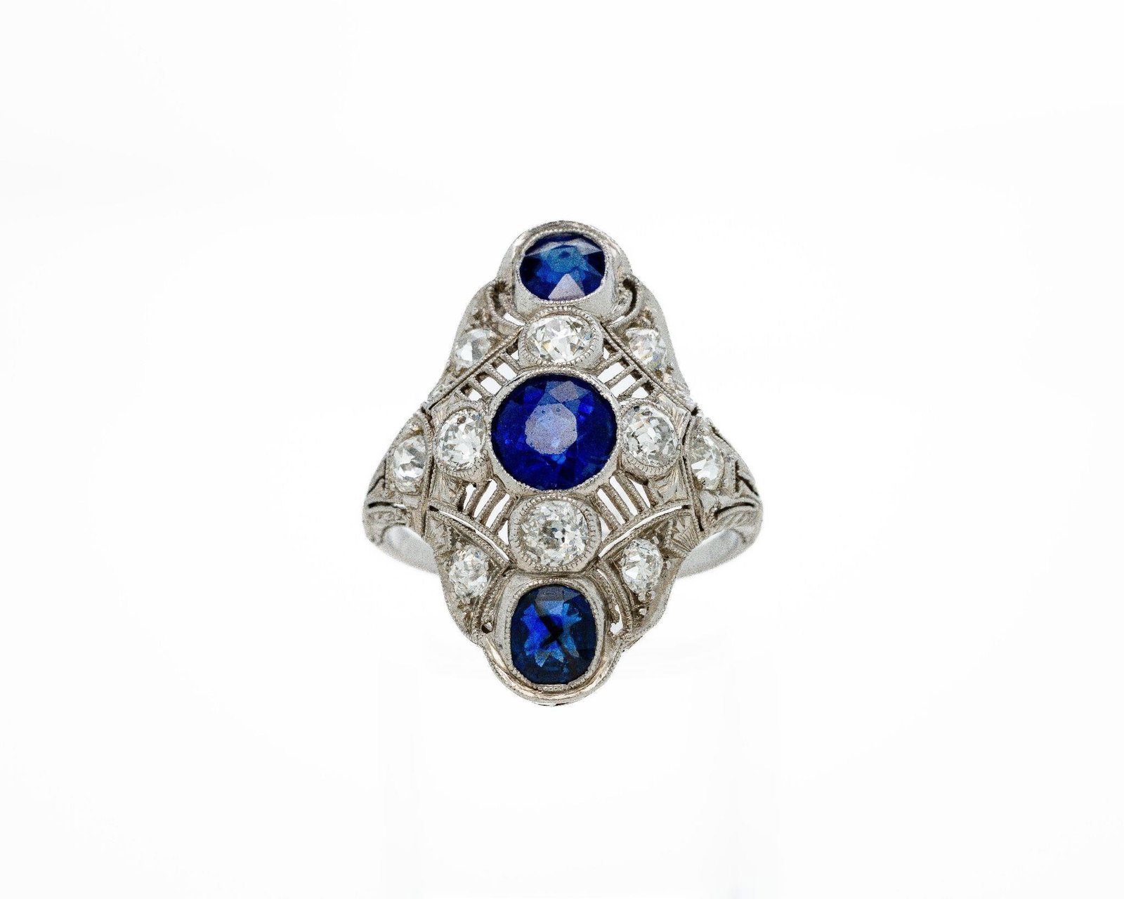 Art Deco Royal Blue Sapphire Diamond Shield Ring: GIA Royal Blue Sapphire Art Deco Platinum Shield Ring · Triple Sapphire Layout · Old-Cut Diamond Accents An exceptional and highly collectible Art Deco platinum sapphire and diamond shield ring;