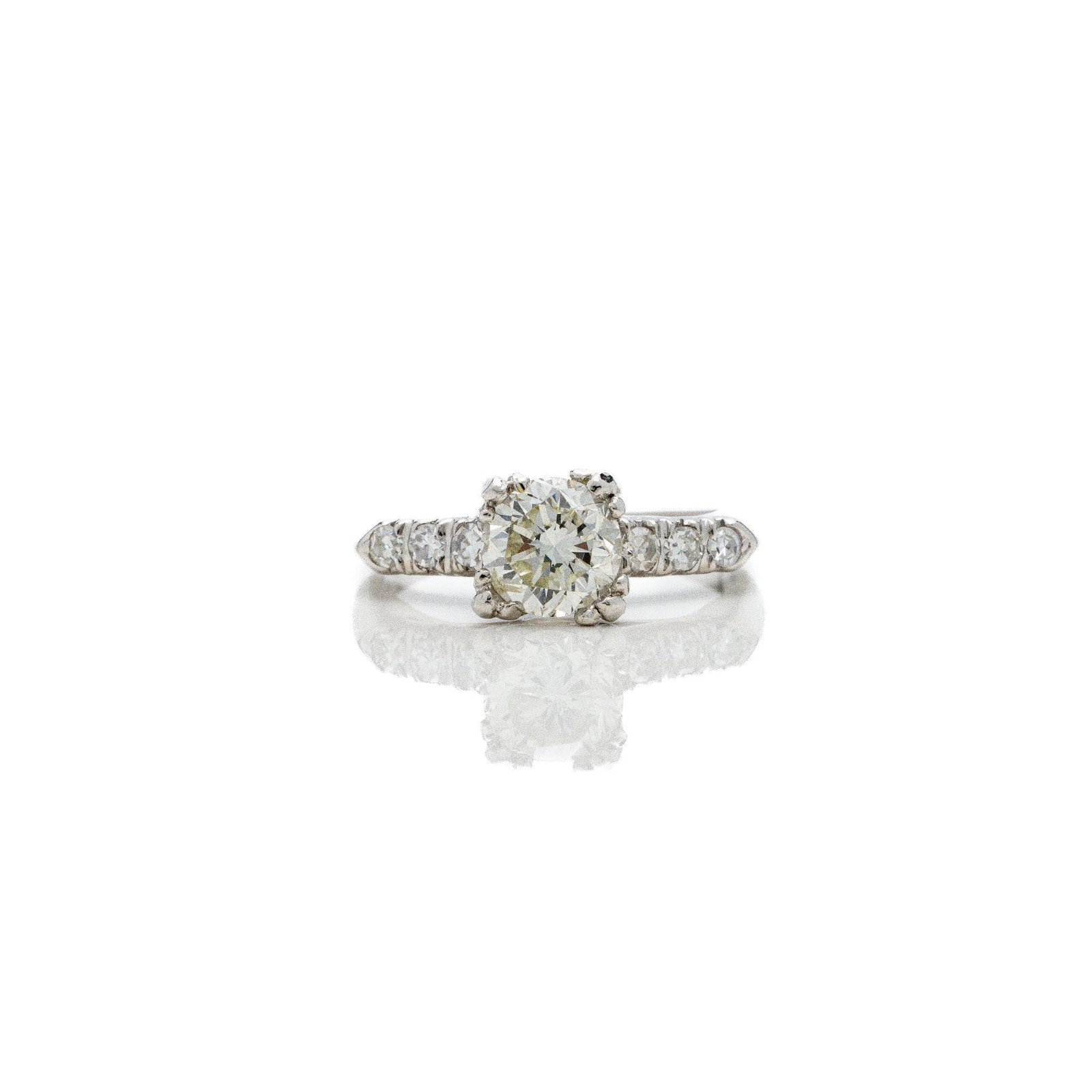 Antique Art Deco Platinum Diamond Engagement Ring: Authentic Art Deco Platinum Diamond Engagement Ring · 1.50 ctw · 1.20 ct Center · Circa 1930s A genuine Art Deco engagement ring dating to the 1930s; masterfully crafted in platinum with a 10%