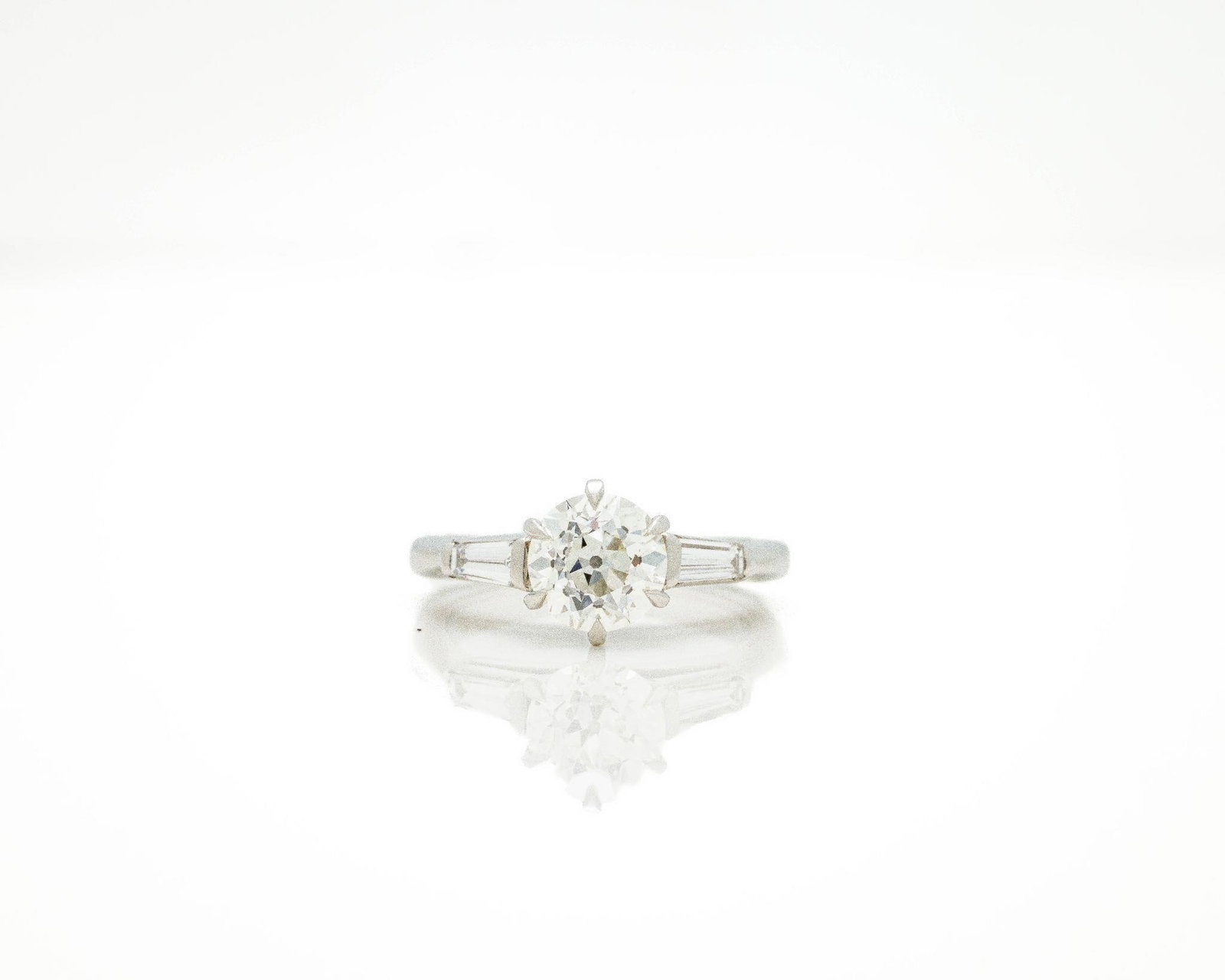 Antique Platinum GIA Certified Round Diamond Ring: Antique Platinum GIA 1.56 ct Old European Cut Diamond Ring - VS2/J - Tapered Baguette Accents An exceptional antique engagement ring in solid 900 platinum; featuring a GIA-certified 1.56-carat natural