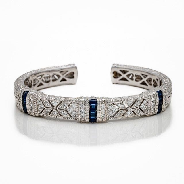 Judith Ripka 18kt Gold Sapphire Diamond Bangle: Judith Ripka 18kt White Gold Sapphire & Diamond Open Bangle Bracelet An elegant and substantial estate bracelet by Judith Ripka; crafted in solid 18kt white gold and finished with the designer's signa