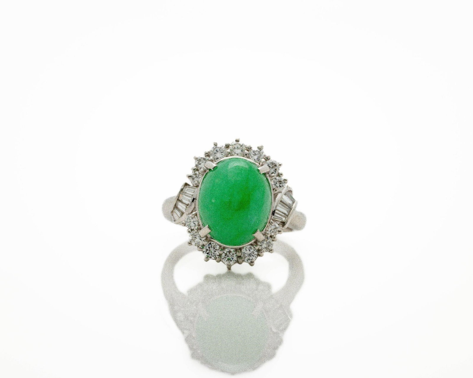 Platinum 6.49ct Cabochon Jade Diamond Halo Ring: Vintage Platinum Jade & Diamond Halo Ring - 6.49 ct Total - Estate A distinguished vintage platinum ring centering a 5.74-carat natural oval cabochon jade of rich; even green tone and fine translucenc
