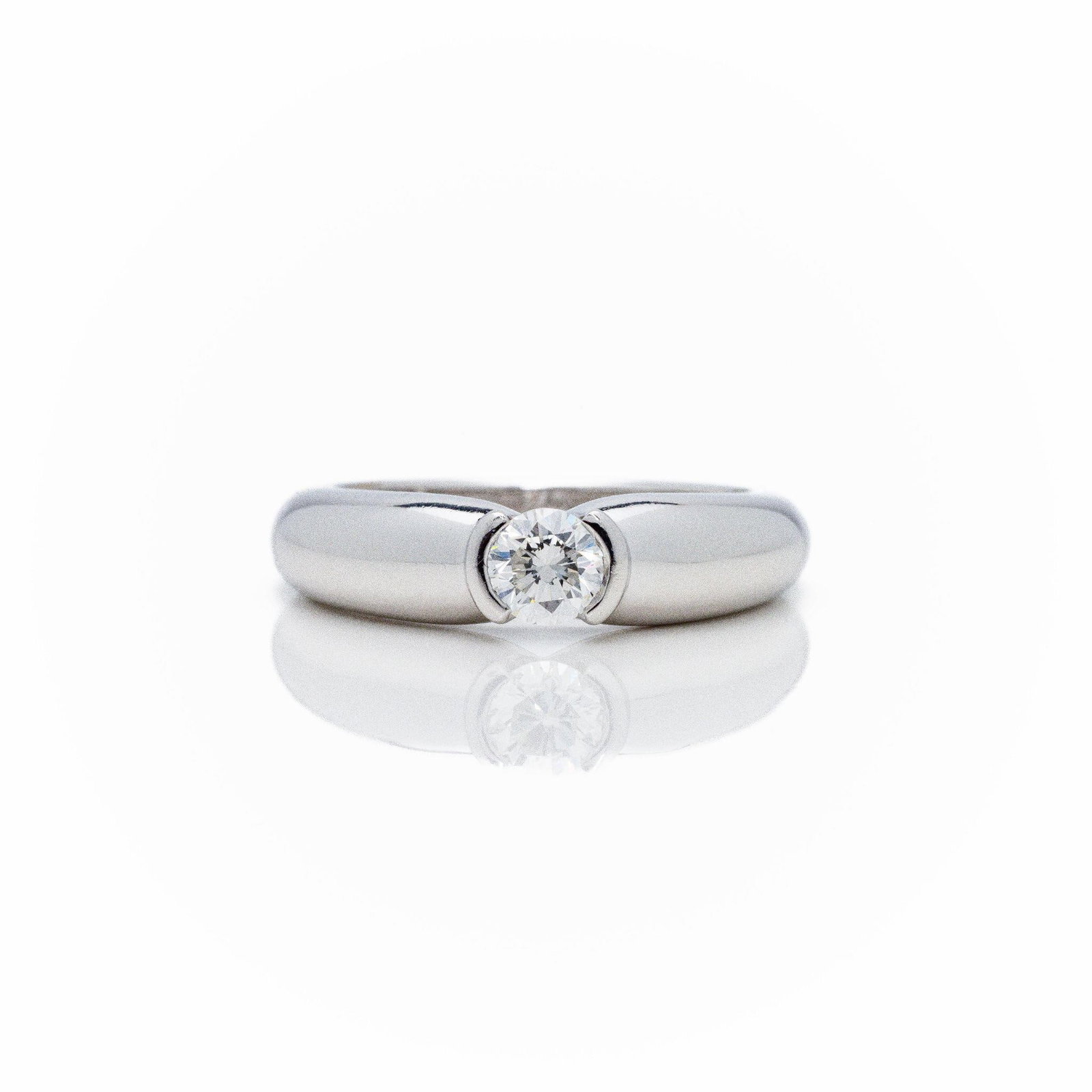 Cartier 18k WG Round Bezel Diamond Solitaire Ring: Cartier 18k White Gold Solitaire Ring - 0.27ct E/VVS Diamond - Signed - 1996 - Size 5 This is a 100% authentic Cartier diamond ring; crafted in solid 18k white gold and featuring a stunning 0.27 carat