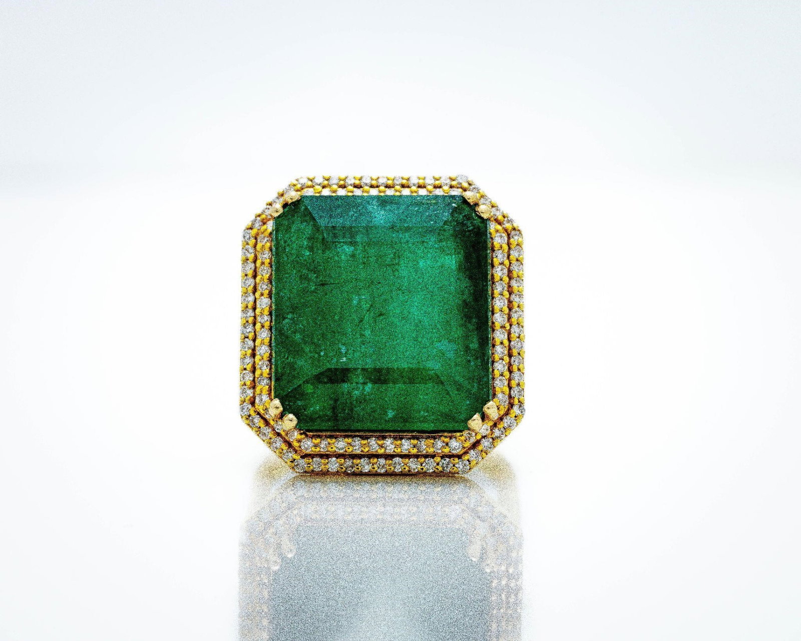 14k 25.90 ct Zambian Emerald & Diamond Halo Ring: 14K Gold 25.90ct Zambian Emerald Diamond Halo Ring This exceptional estate ring features a monumental 25.90-carat natural Zambian emerald in a square radiant cut; prized for its deep green saturation 
