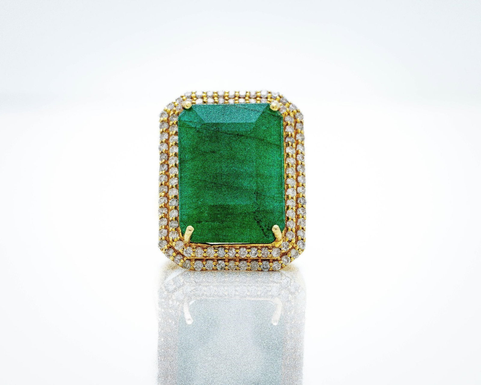 14K Gold 7.85ct Zambian Emerald Diamond Halo Ring: 14K Gold 7.85ct Zambian Emerald & Diamond Halo Ring This striking estate ring showcases a 7.85-carat natural Zambian emerald; expertly emerald-cut and set in 14K yellow gold. A halo of 0.55 carats of