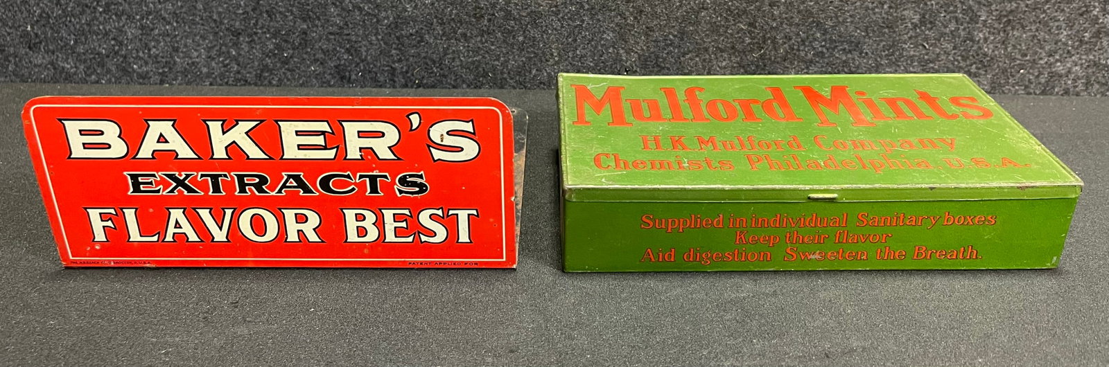 Pair Original Tin Advertising Lot: Baker's Extract Book Holder & Mulford Mint Tin: Great original advertising pair. 8.25" x 4.25" x 1.5" (mulford) - 7.5" x 5.5" x 3" tall (bakers)