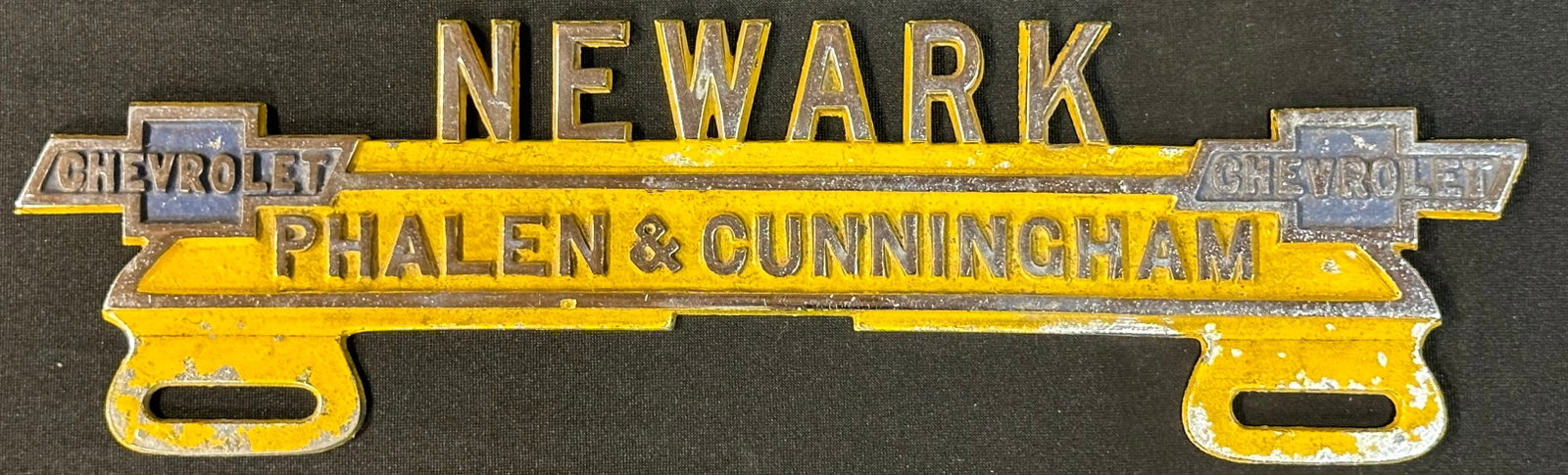 Newark Phalen & Cunningham Chevrolet Embossed Cast Aluminum License Plate Topper: 11.25" x 3.5" - nice original paint.