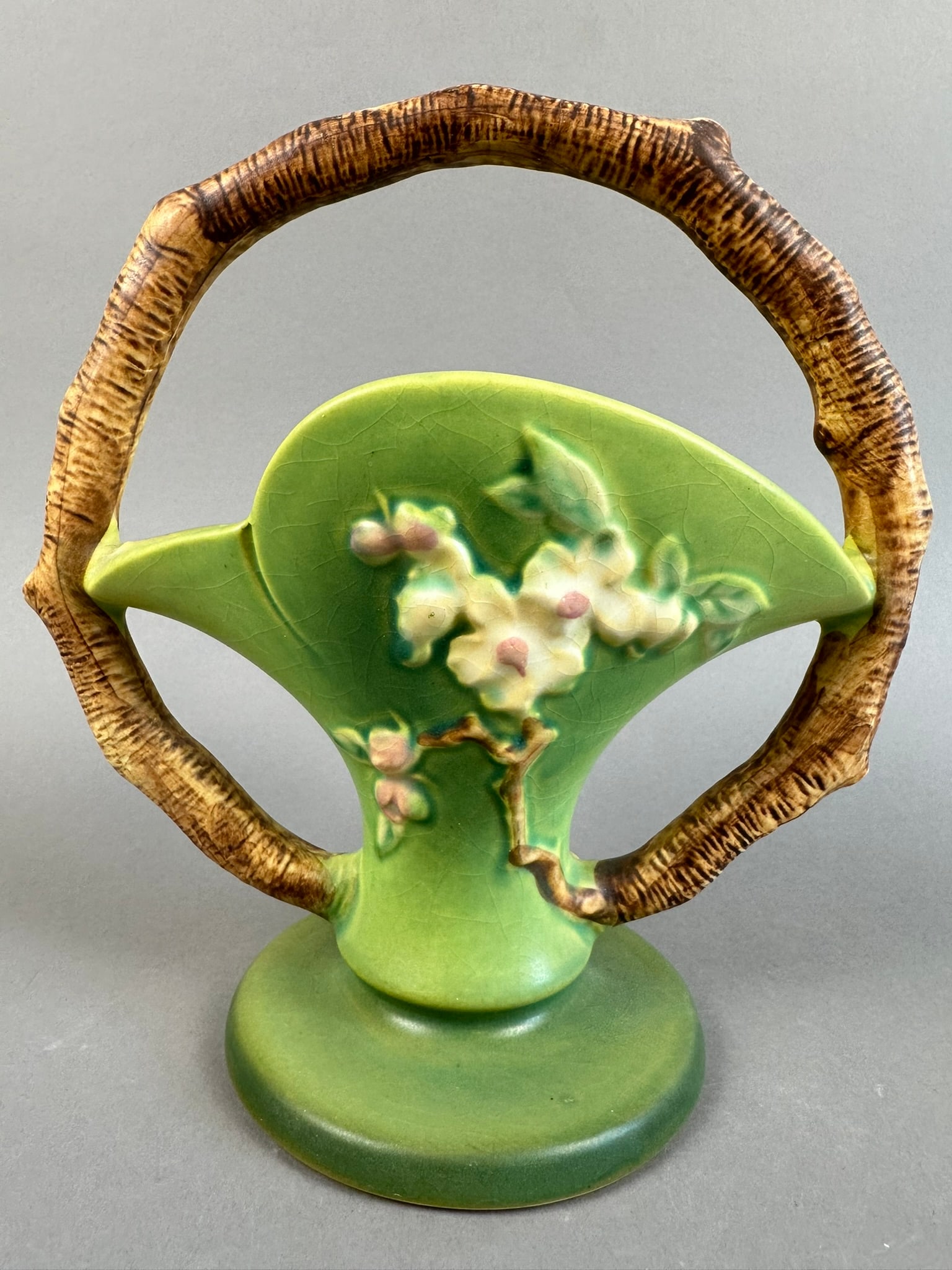Roseville Pottery Green Apple Blossom Basket 309-8: Beautiful Roseville Pottery Green Apple Blossom basket. Great colors on this one, some crazing as to be expected for age. Overall measurements are 8"x4.5"x9".