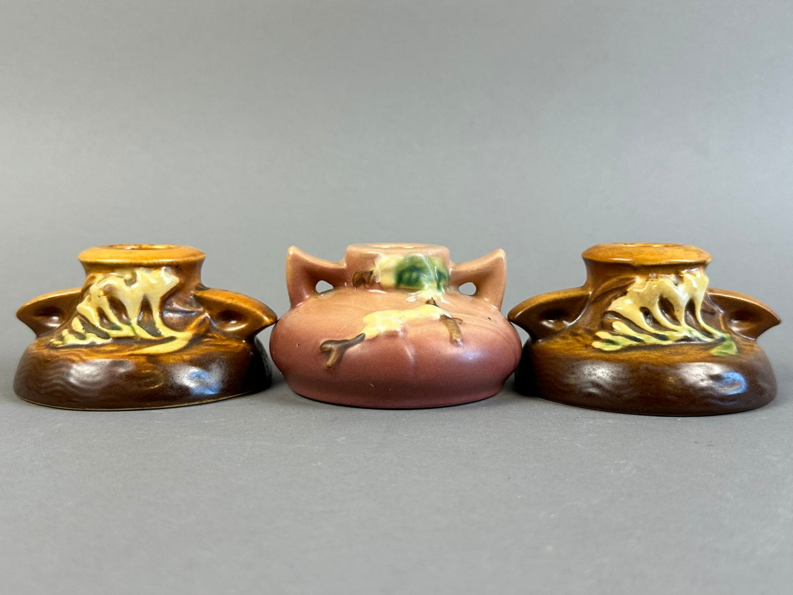 Roseville Pottery 3 Piece Lot Freesia Candlestick Lot: Beautiful Roseville Pottery 3 piece lot, featuring a pair of Freesia pattern candlesticks and a single snowberry dusty rose pattern.