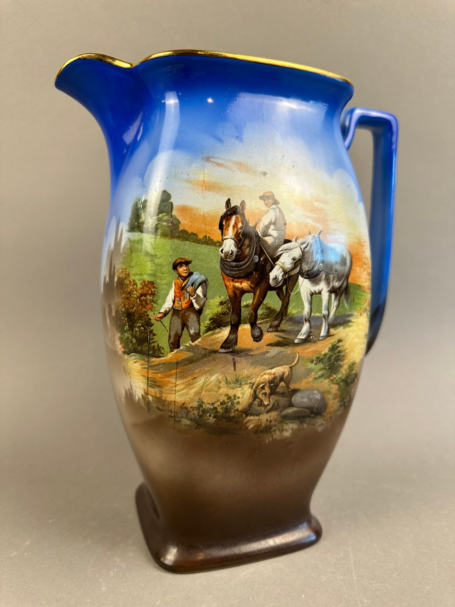Silvo Handpainted English Country Scene Pitcher: Beautiful handpainted Silvo made in England pitcher featuring a western horse scene, beautifully decorated. Excellent condition. Overall measurements 9"x5"x11".