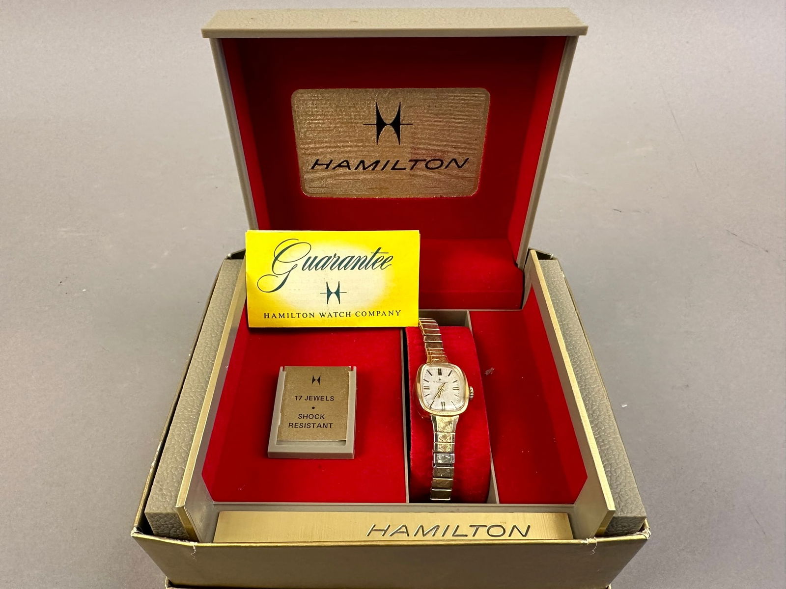 Hamilton Mid Century Era Ladies Watch NOS Box 10K: Beautiful mid century era Hamilton wrist watch in original box and papers. Watch is marked 10K R.C.P. Bezel. Please review pictures for measurements.
