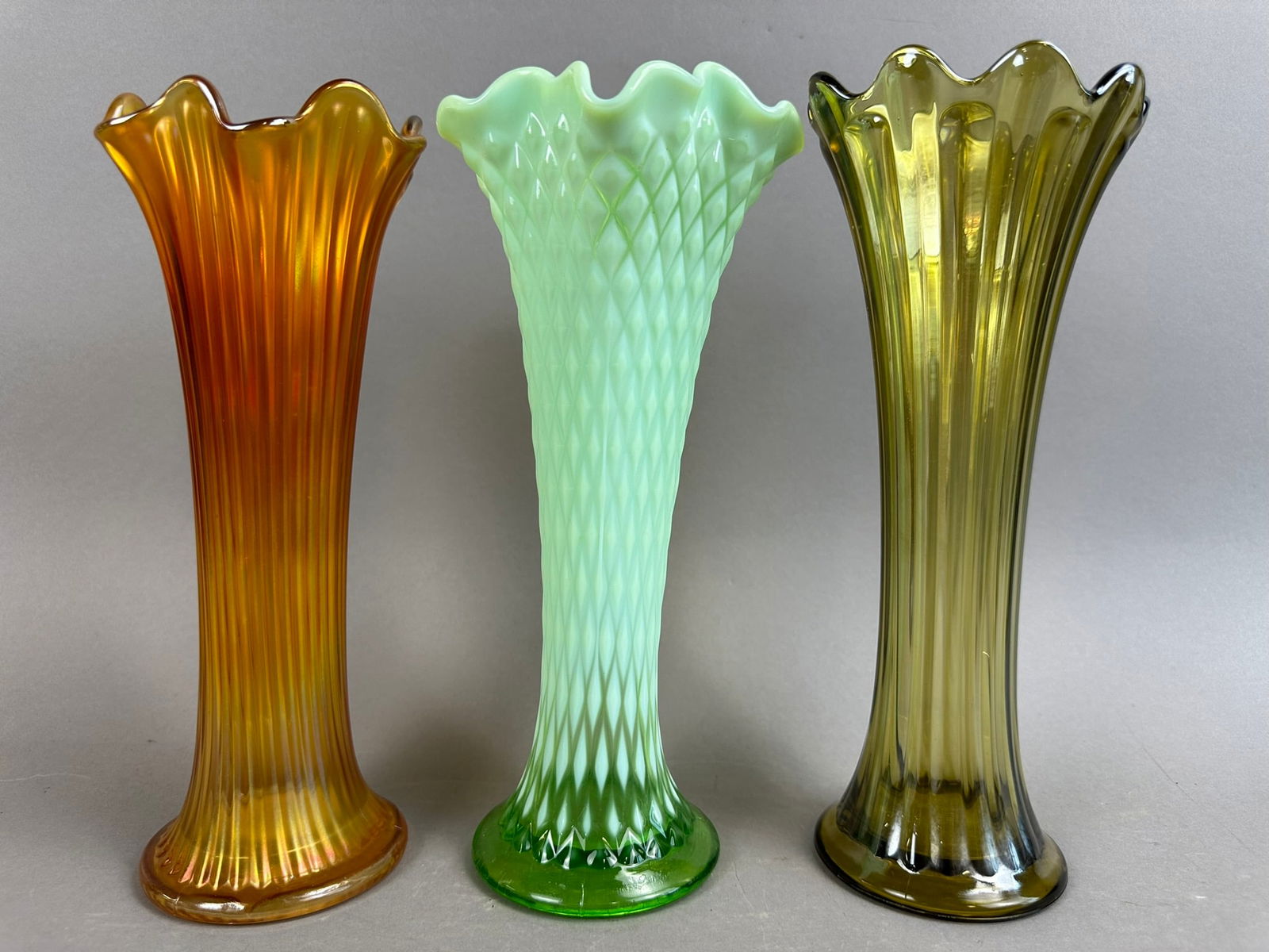 3 Fenton Northwood Marigold Carnival Swung Vases: Beautiful lot of 3 pieces, 2 Fenton and a lime colored diamond point Northwood piece. Sizes vary per piece, please review pictures for measurements.