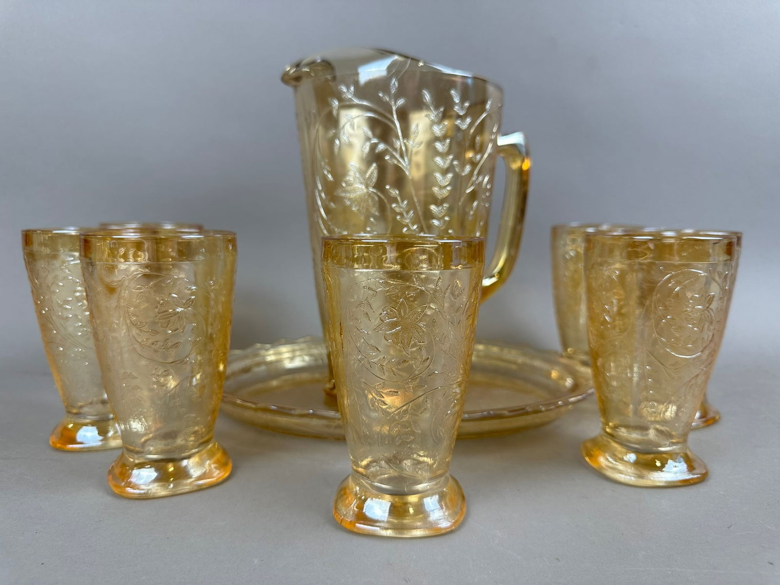 Jeannette Carinval Glass 9 Piece Matching Water Set: Beautiful 9 piece Jeannette Carnival Glass lot featuring 7 tumblers, water pitcher, and snack tray. Please review pictures for measurements.