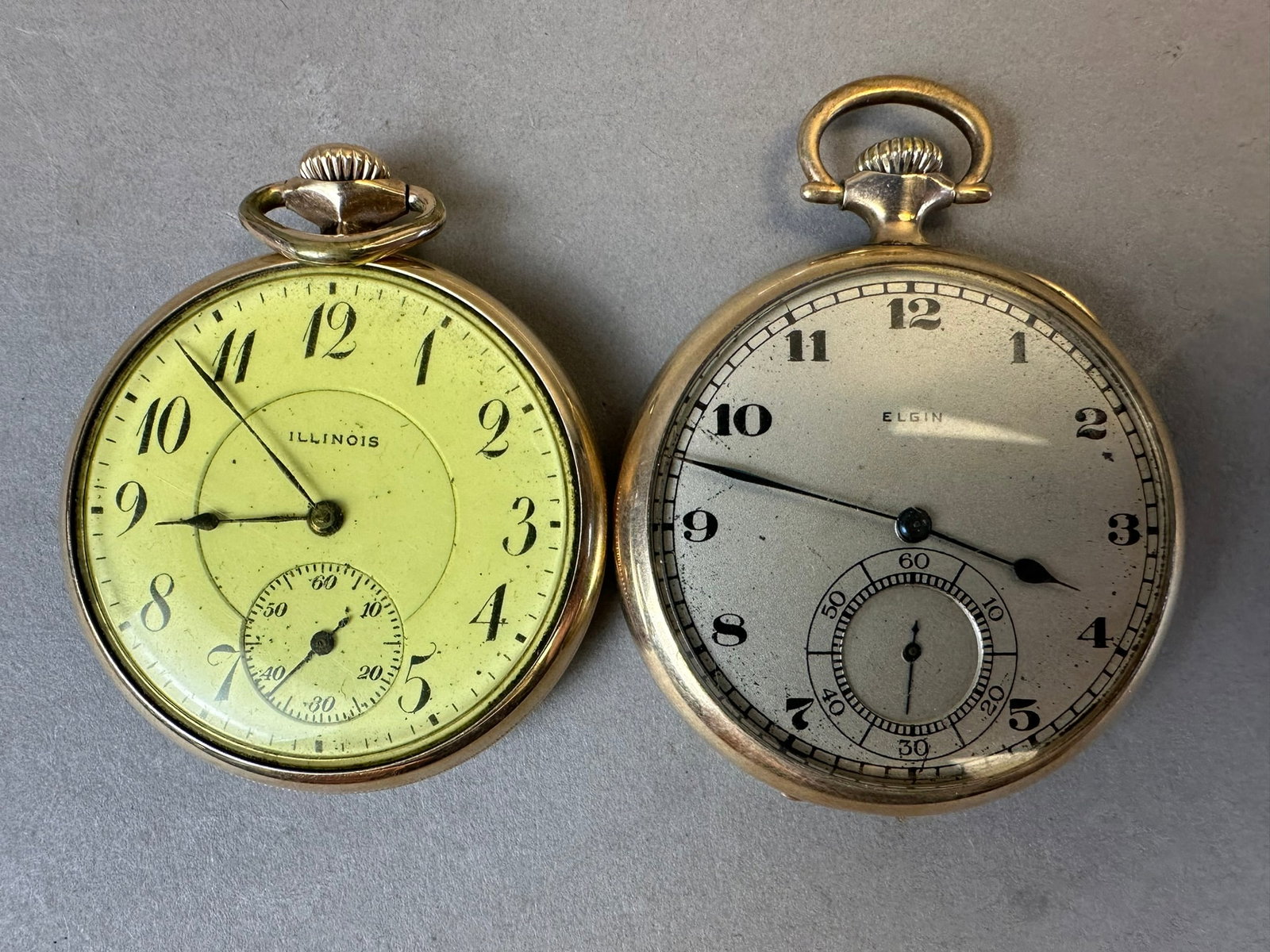 Pair 10K Gold Filled Pocket Watches Elgin Illinois: This lot consists of an Elgin working pocket watch with a Wadsworth 10k gold filled case, patent dated 10-9-17, marked 5006603. The Illinois watch is in a 10K Dueber marked 1135900, this one is 5 adju