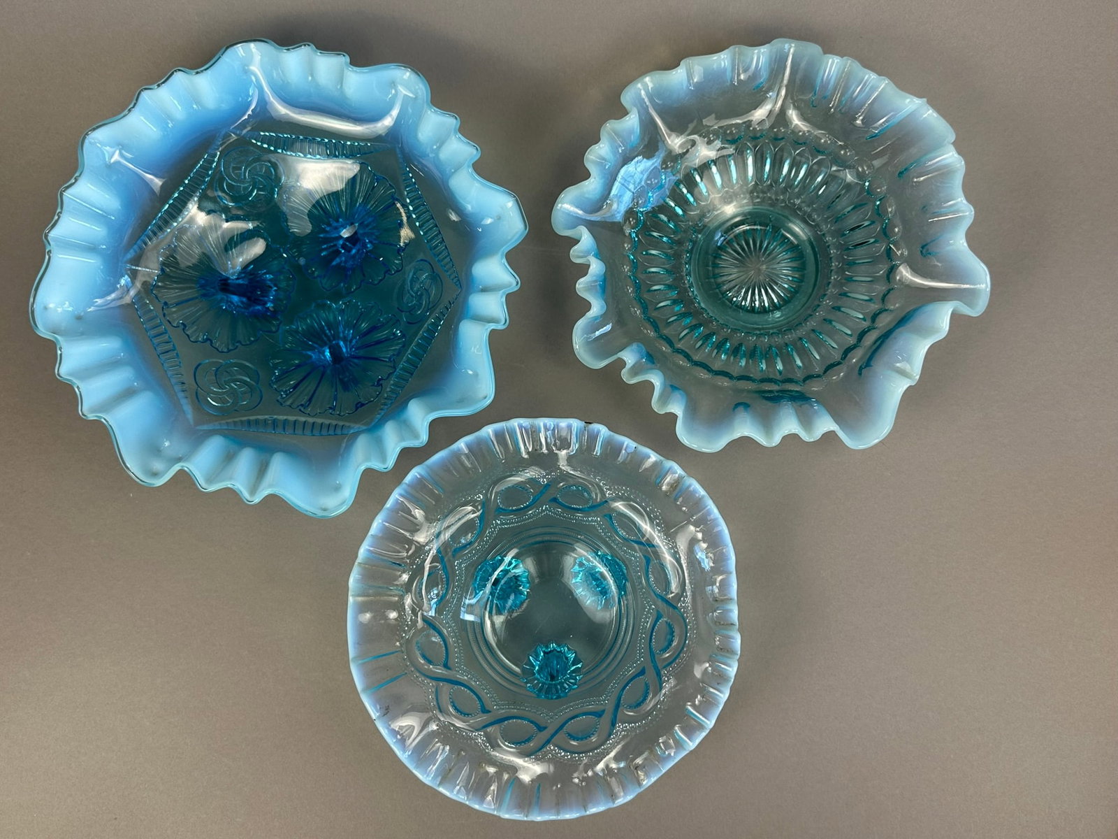 3 Fenton Blue Opalescent Glass Ruffled Footed Bowls: This lot features 3 blue Fenton opalescent ruffled bowls. All 3 pieces are in excellent conditon.
