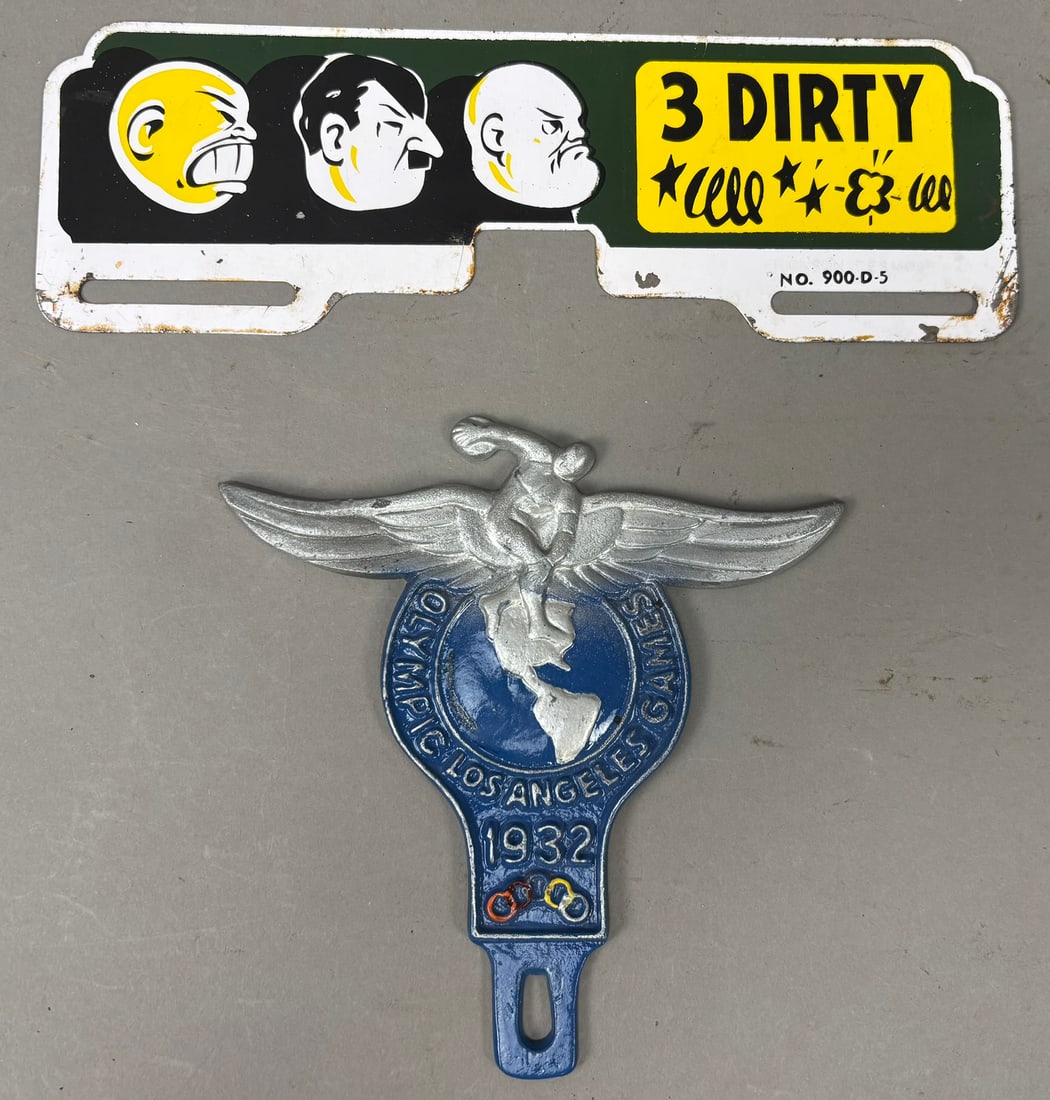 2 License Plate Topper LA Olympics 1932 WW2 Hitler: This lot features 2 license plate toppers, one is from the 1932 Los Angeles Olympics and other is from WW2 era with Hitler and others on it. Please review pictures for best description.