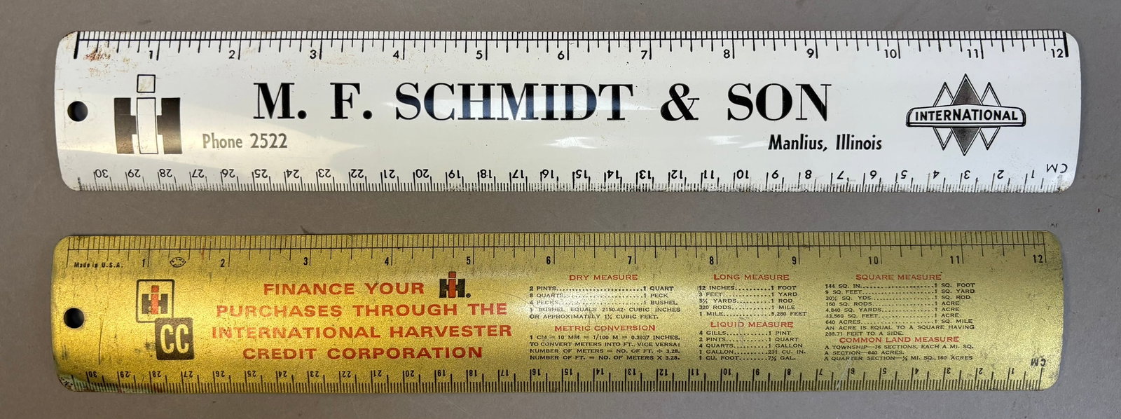 2 50s International Harvester Advertising Rulers: This lot features a pair of metal advertising rulers for International Harvester, one is for a dealer in Manilus Illinois and other is advertising for IH Credit. Please review pictures for best descri