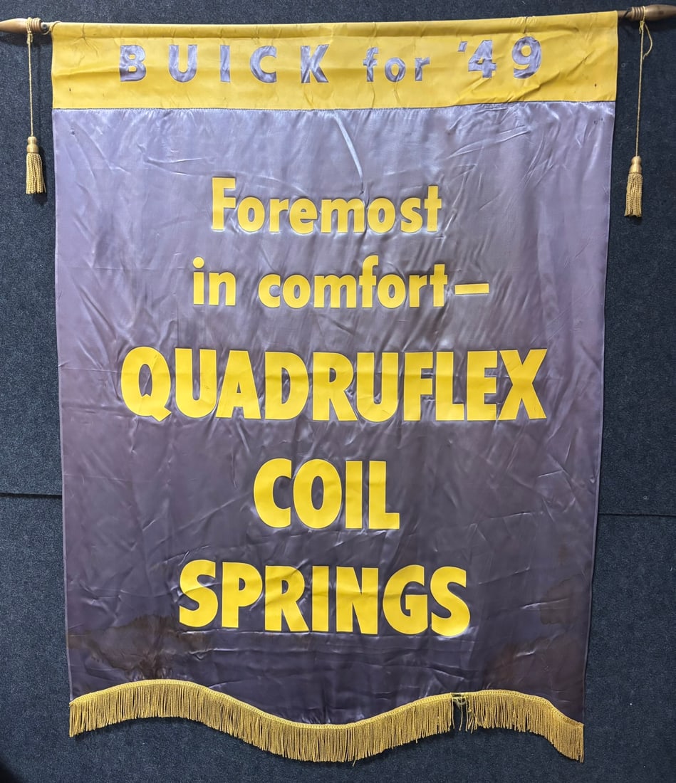 Buick 1949 Quadruflex Coil Springs Showroom Banner: This lot features a 1949 Buick Dealership advertising showroom banner for Quadruflex Coil Springs. Has some spots of fringe loss, wear, loss and stains, please review all pictures for best description