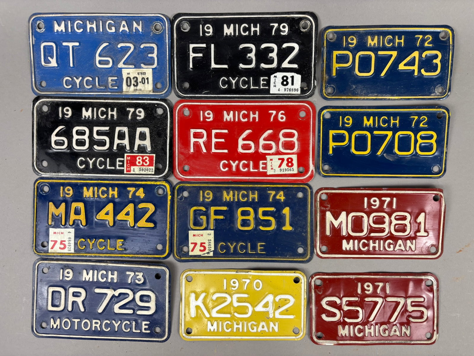 12 Original 70s Michigan Motorcycle License Plates: This lot features 12 original Michigan Motorcycle License plates mostly 11 from 1970-1979, 1 maybe early 2000s. Please review all pictures for best description.