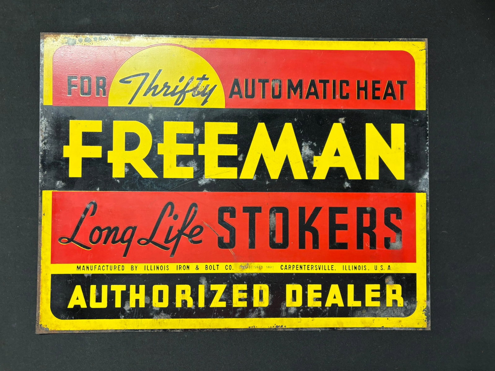 Freeman Long Stokers Advertising SST Dealer Sign: This lot features an original single sided painted metal sign for Freeman Long Life Stokers Authorized Dealer. Sign has some edge wear and loss. Please review all pictures for best description and mea
