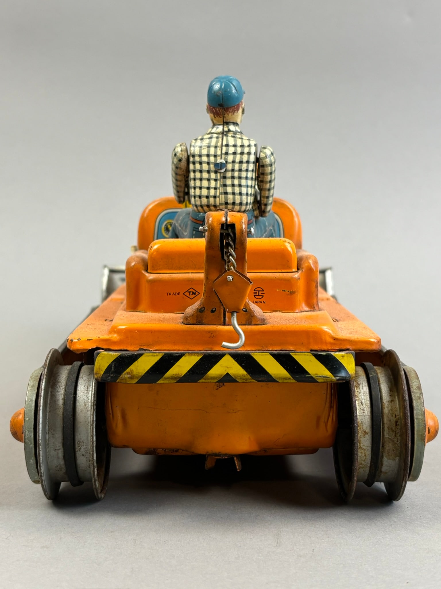 Nomura Battery OP Handy Hank Bulldozer Tin Toy: This lot features a Nomura tin battery operated Handy Hank Bulldozer Japanese tin toys. Toy powered on, lit up and moved around and also maybe missing pieces. Overall measurements are 6"x10.75"x6.25".