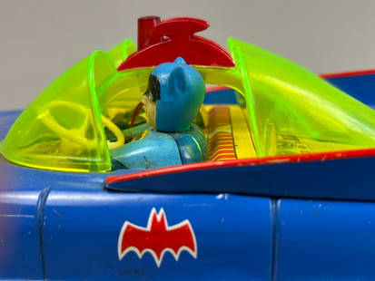 2 ASC Cragstan Batmobile Tin Friction Battery OP Toys: This lot features a pairing of tin friction battery operated Batmobiles, 1-ASC, 2-Cragston. The ASC has some bends in wheels, and bottom cover may have been repainted. The Cragston appears to have bee