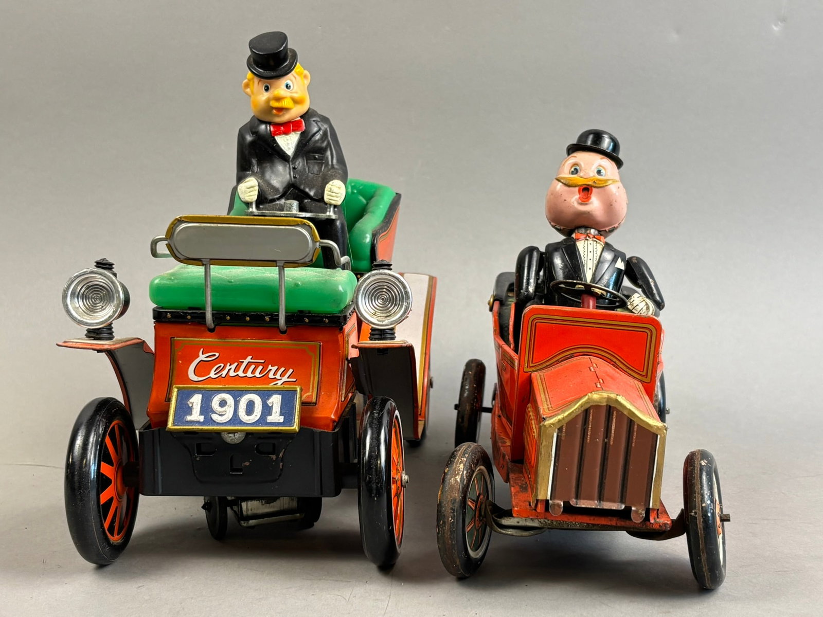2 Nomura Tin Battery OP Smoking Bill Jalopy Toys: This lot features a pairing of Nomura Japanese tin battery operated jalopy cars. 1-Smoking Bill, 2-Century 1901. Century 1901 is inop, Smoking Bill powers on when tested and has limited function and m