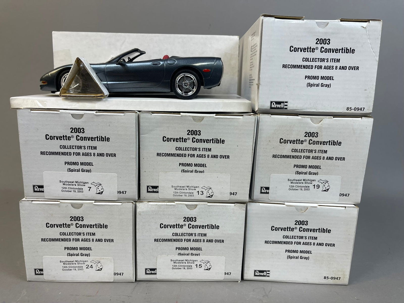 7 NOS Revell 03 Chevrolet Corvette Conv Promo Car: This lot features 7 NOS Revell 2003 Chevrolet Corvette Convertible Promo cars in Spiral Gray. These were set up for the Southeast Michigan Modelers Toy Show and some have stickers. All tpys are in ori