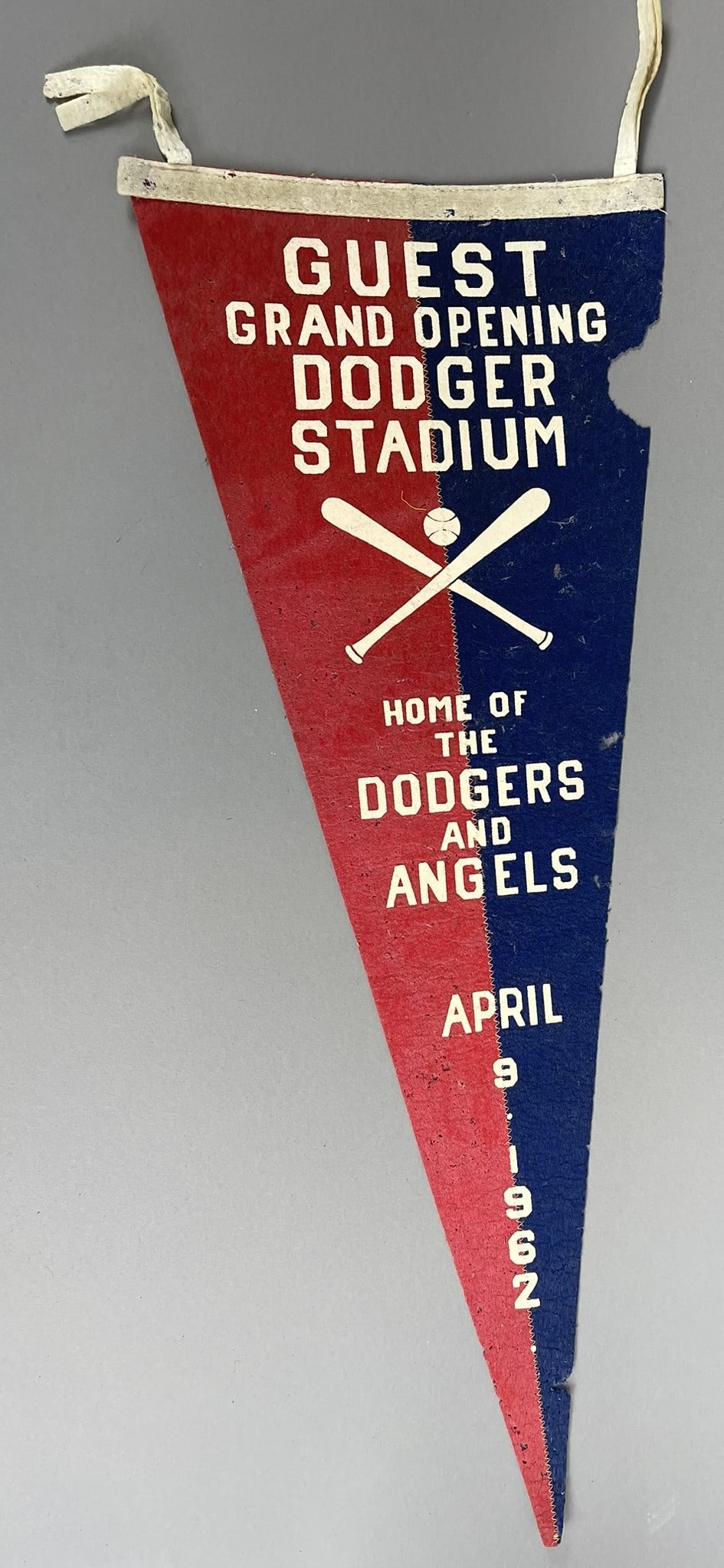 April 9 1962 Grand Opening Dodger Stadium Felt Pennant 29": Vintage pennant in fair-good condition and shows some moth bites, side fabric and tip loss. Tassels intact. Measures 29" . See all photos